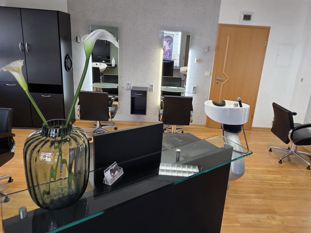 Empfangsbereich mit Blick auf die Frisierplätze im Friseursalon Häfner